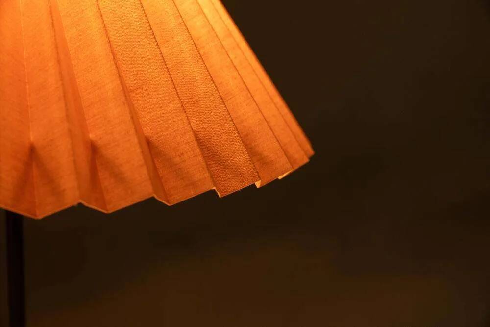 Minimalist glass table lamp from the 80s with a pleated shade.