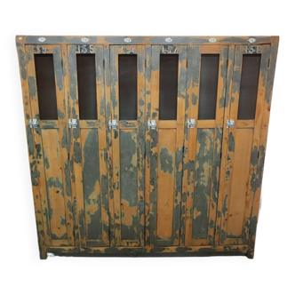 Old industrial wooden locker room with six doors, gray patina