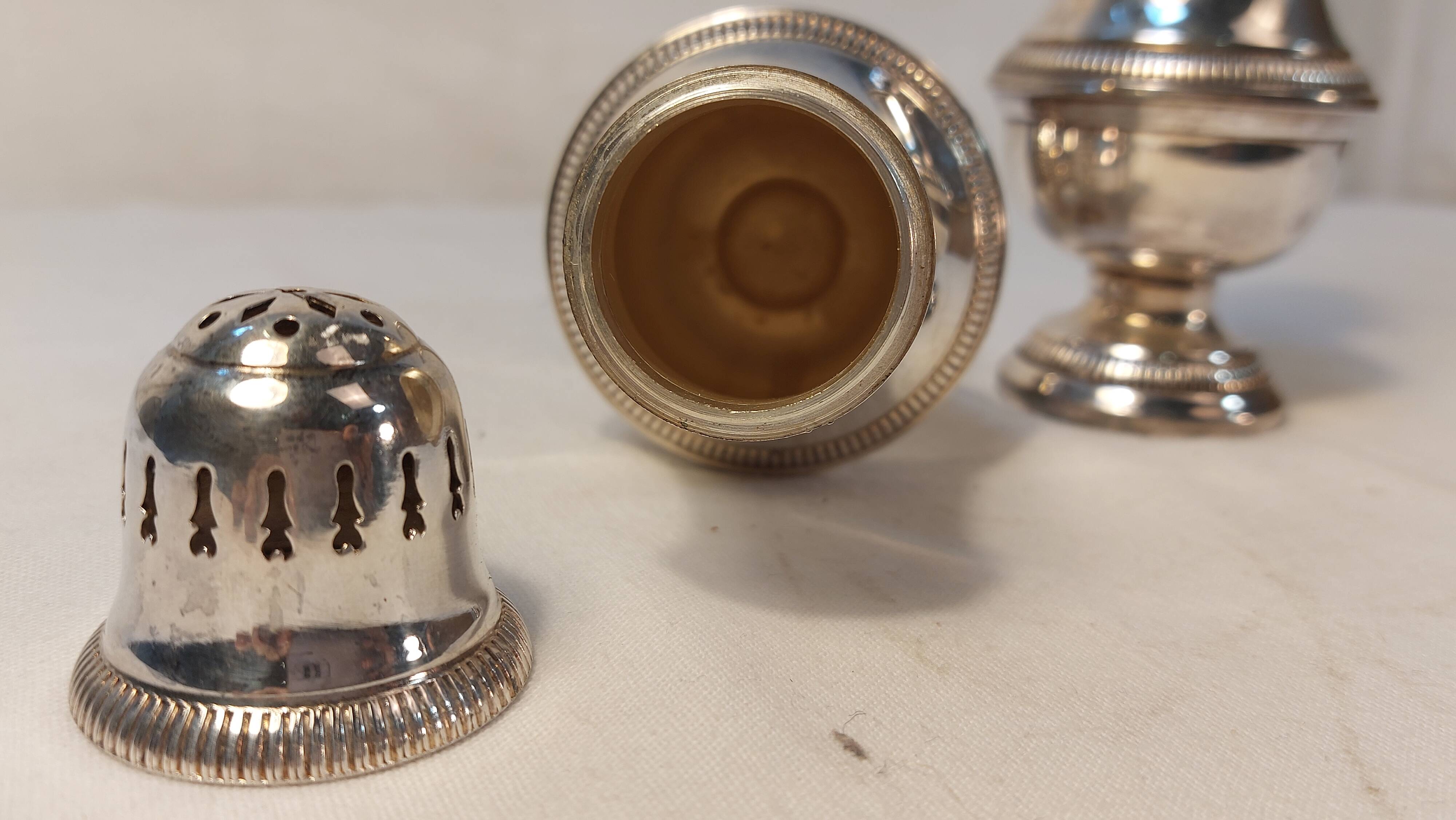 Set of two silver metal sprinklers