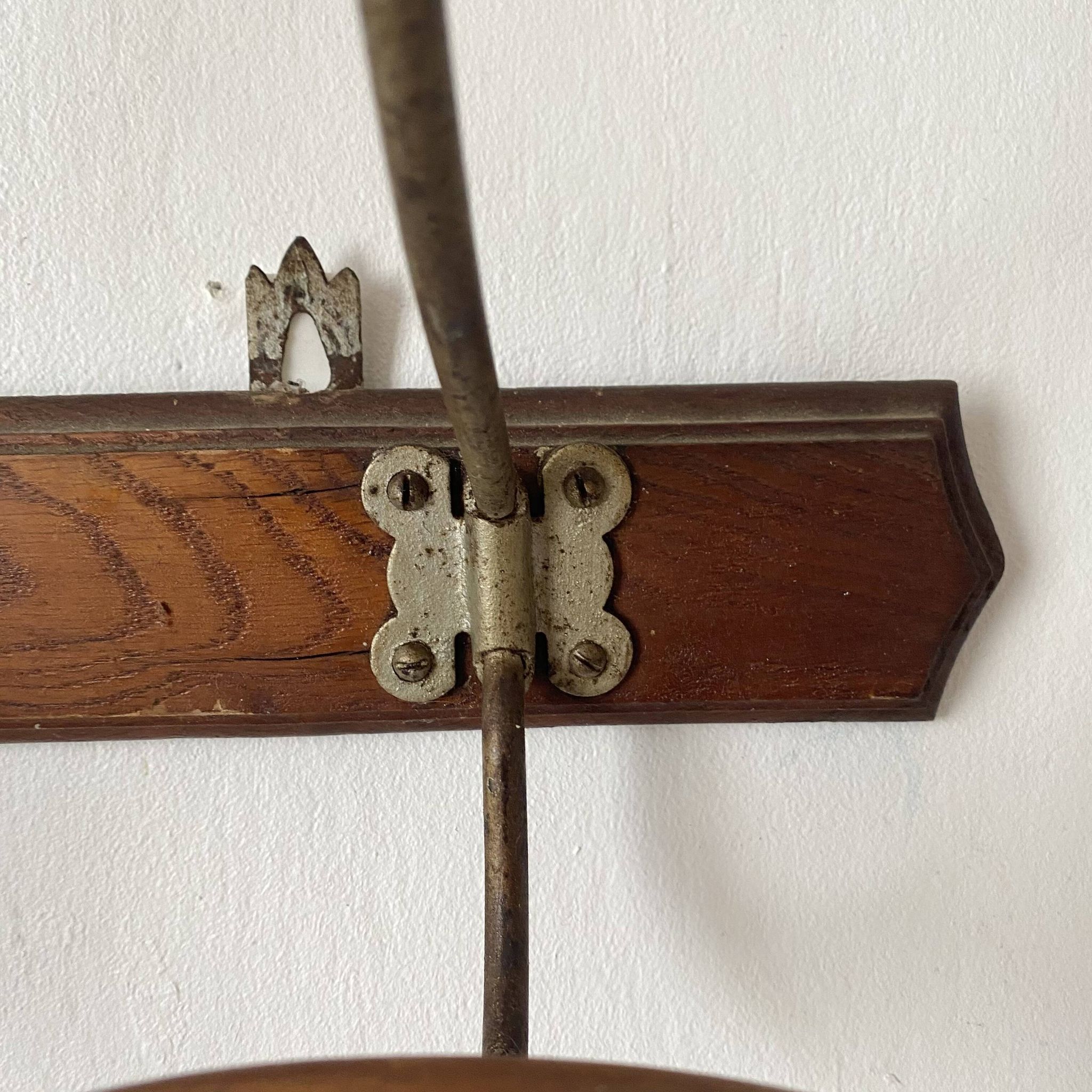 Old wooden and metal wall-mounted coat rack.