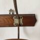 Old wooden and metal wall-mounted coat rack.