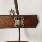 Old wooden and metal wall-mounted coat rack.