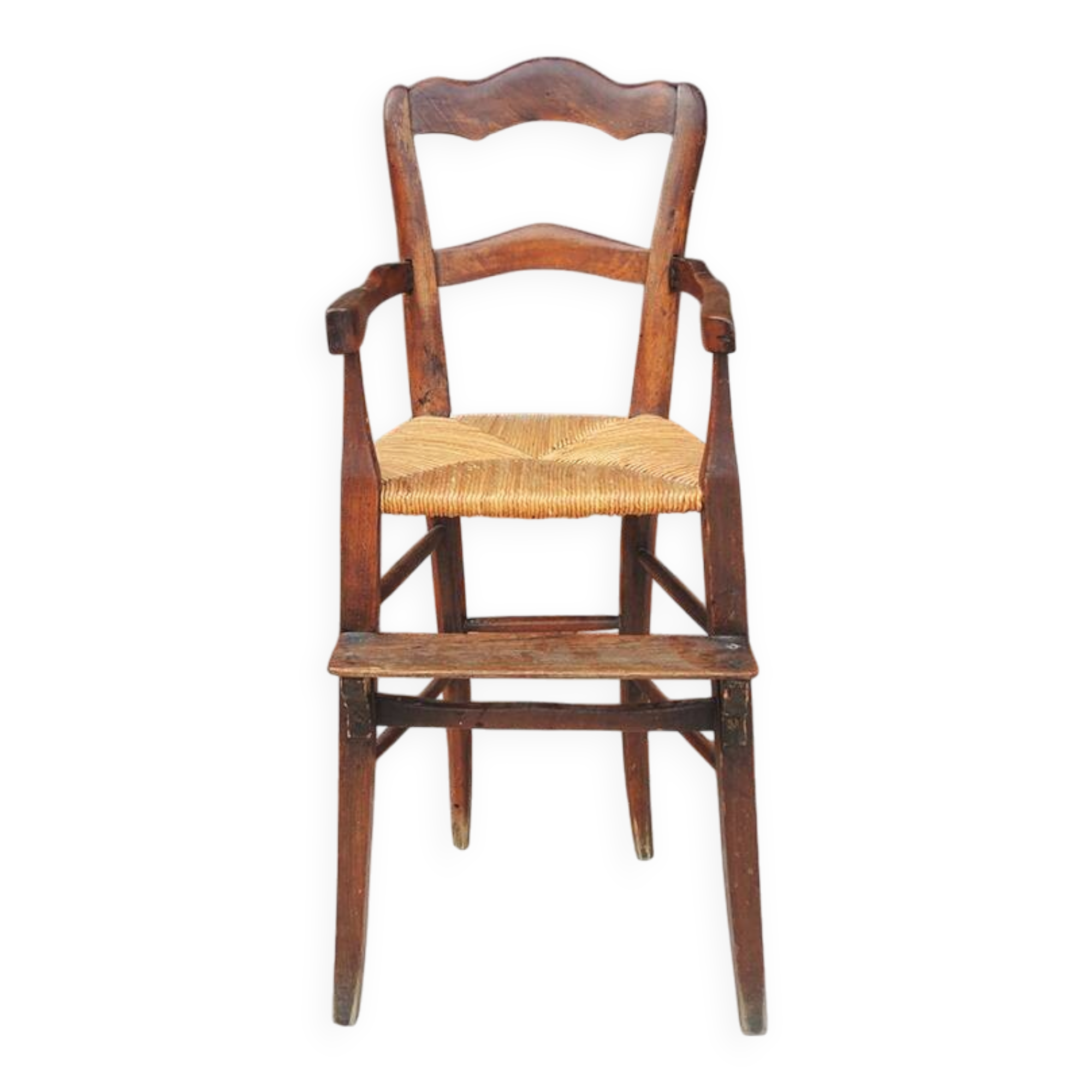 Old wooden high chair for children with straw.
