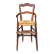 Old wooden high chair for children with straw.