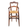 Old wooden high chair for children with straw.