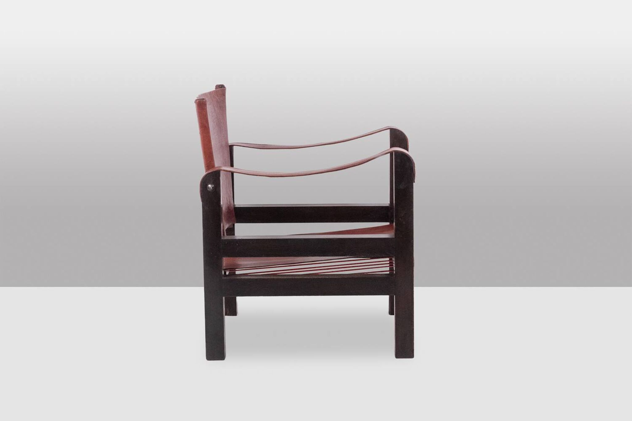 “Safari” armchair in wood and cognac leather. 1960s/70s.