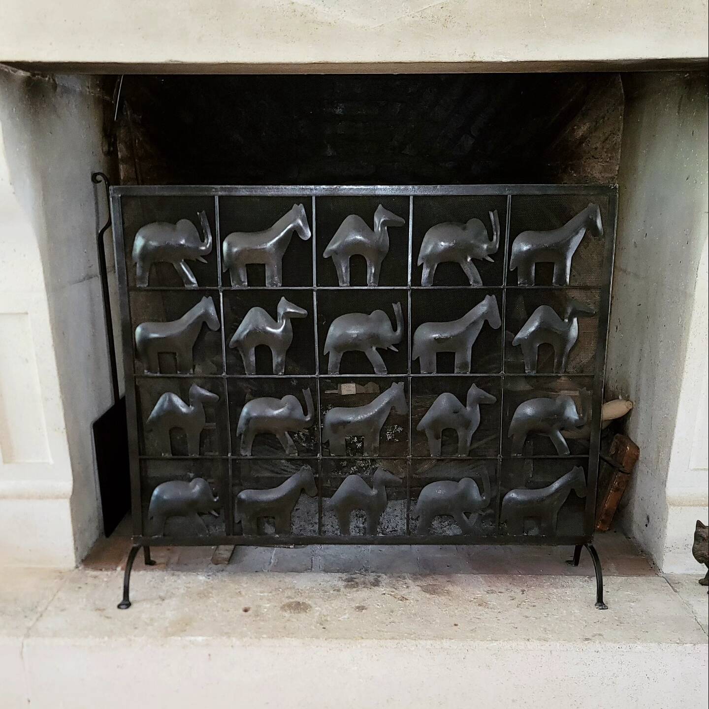 Black metal firewall decorated with animals