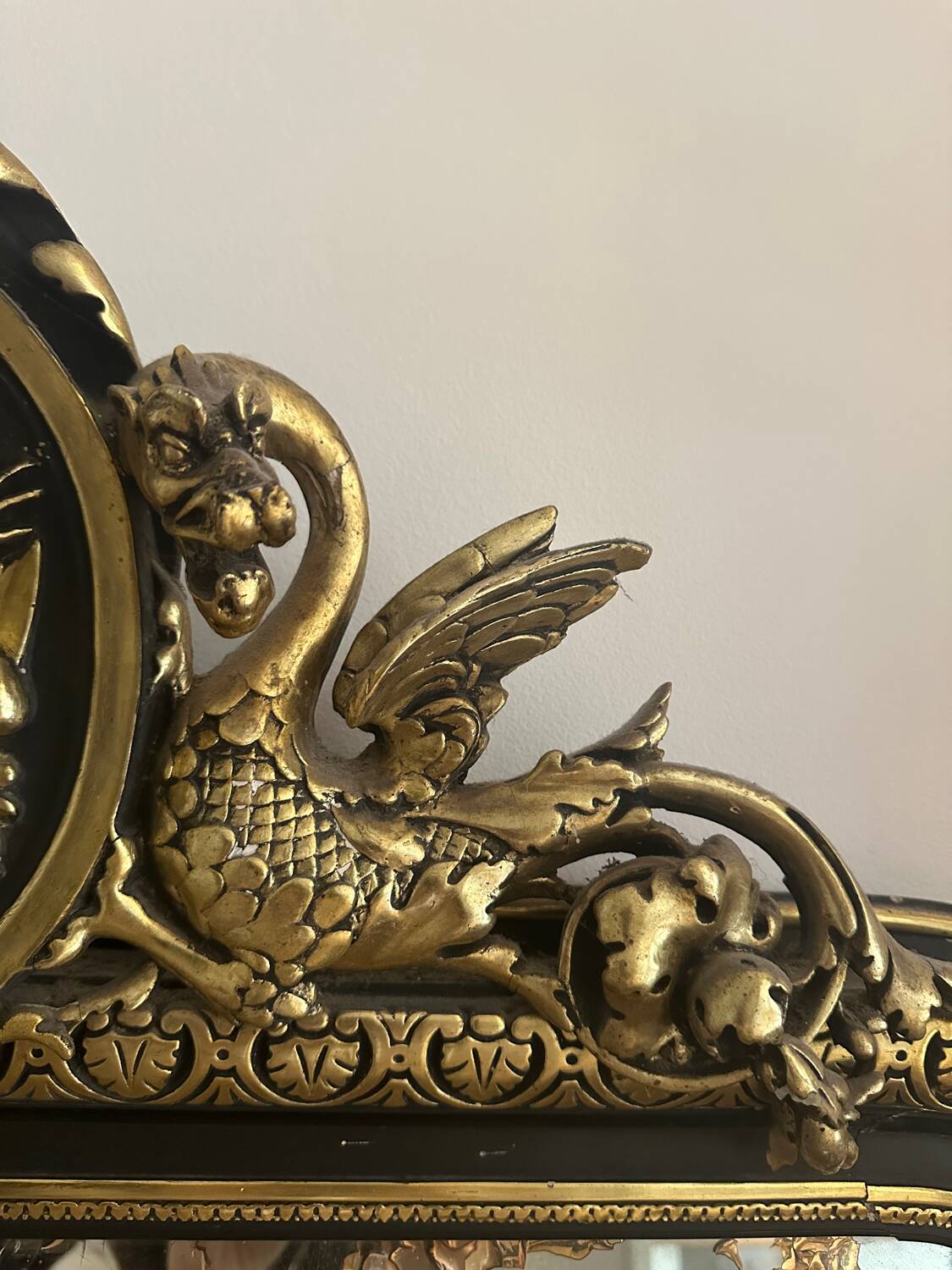 Napoleon III mirror with a pediment featuring black and gold dragons and birds.