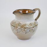 Glazed ceramic jug with plant decoration