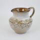 Glazed ceramic jug with plant decoration