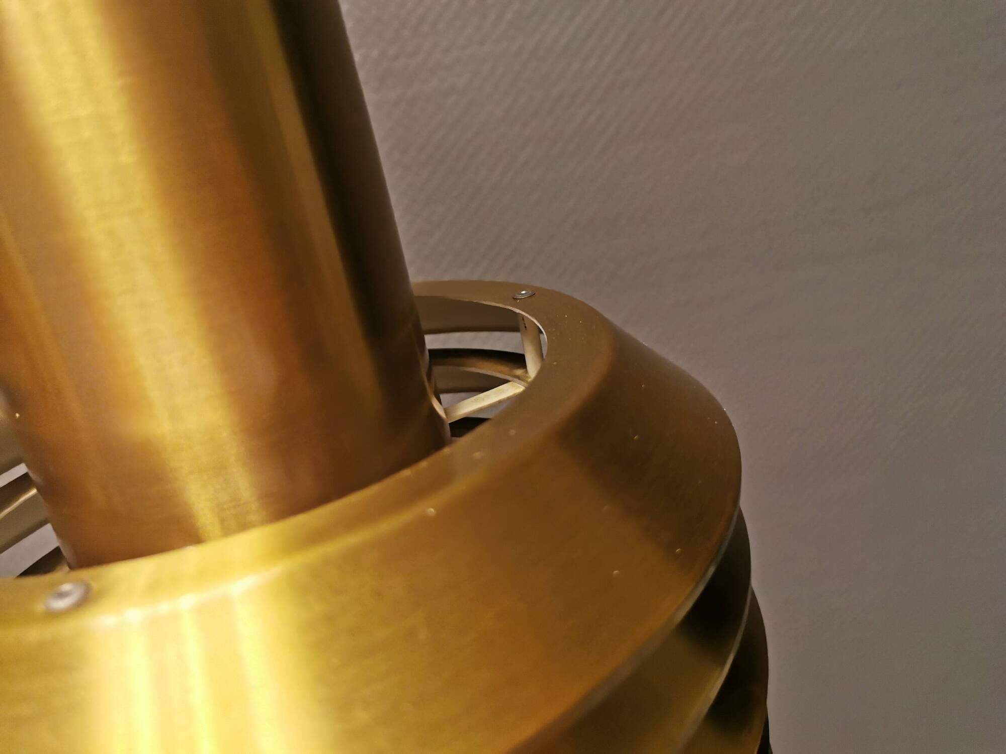 Hanging lamp in gold-colored aluminum with many layers of shades.
