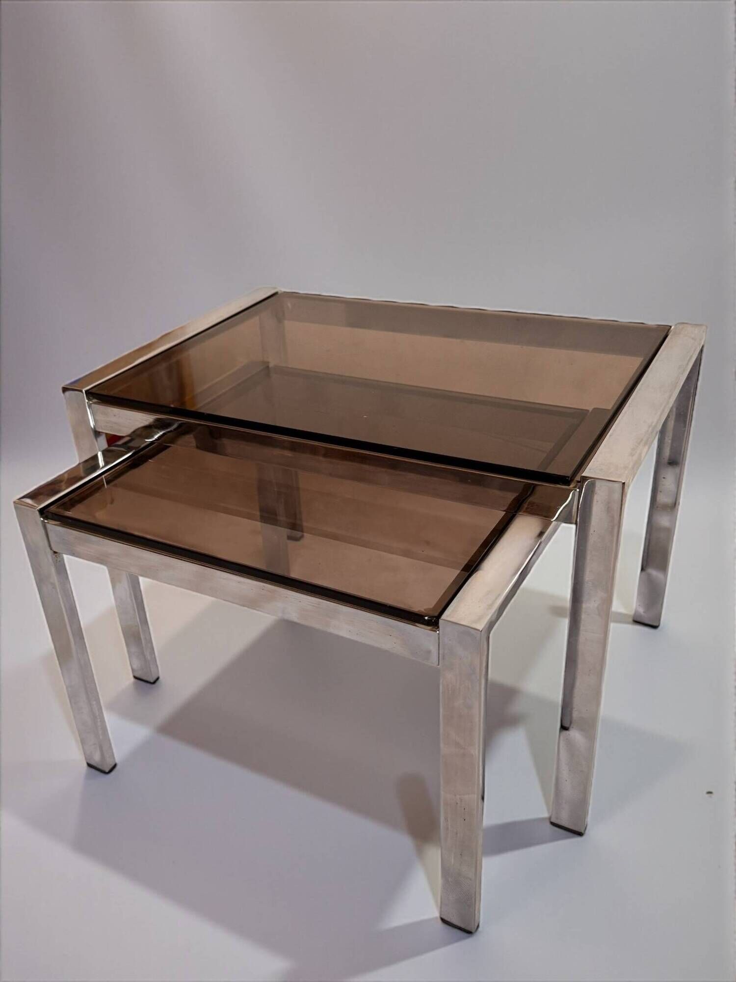 Vintage nesting tables from the 1970s, chrome and smoked glass, mid-century modern.
