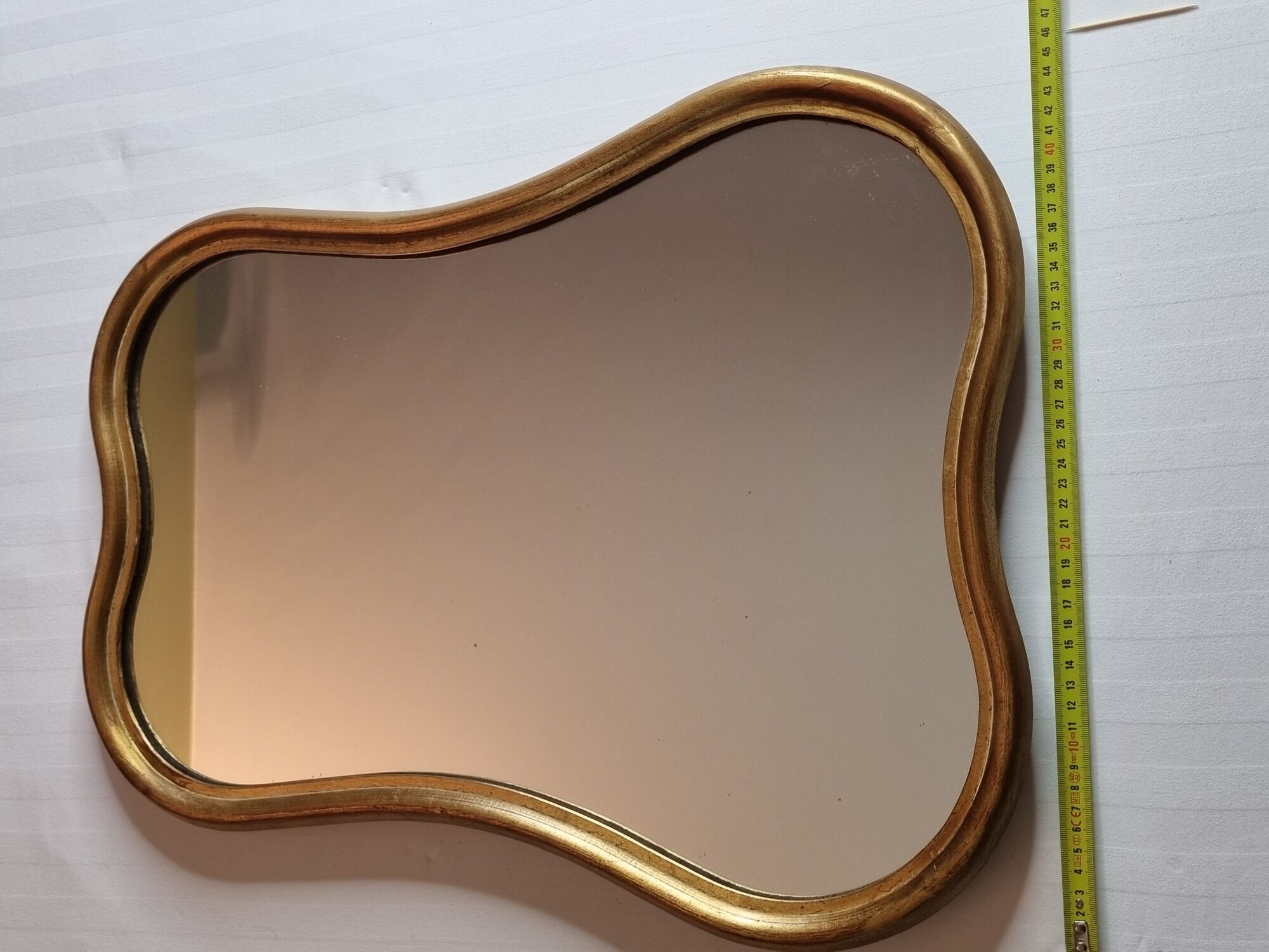 Vintage baroque style mirror, with curved frame in stucco and gilded wood 57 cm