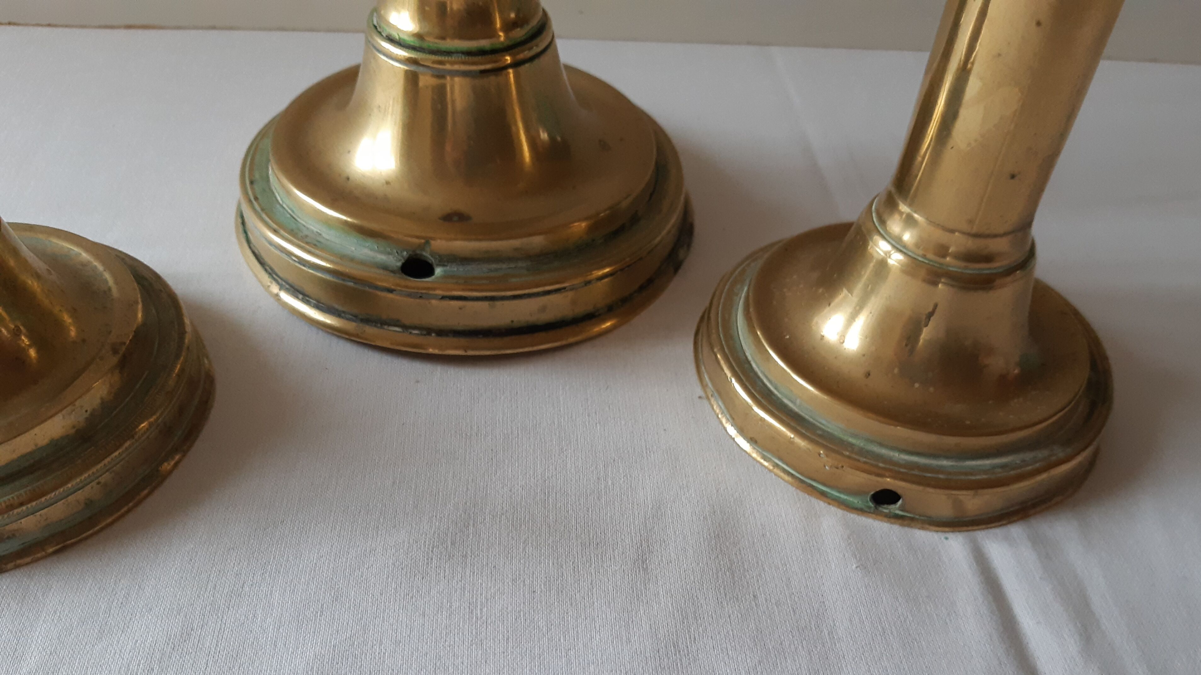 Lot of three old brass candlesticks