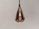 A teardrop-shaped pendant lamp made of copper, black metal, and prisms.