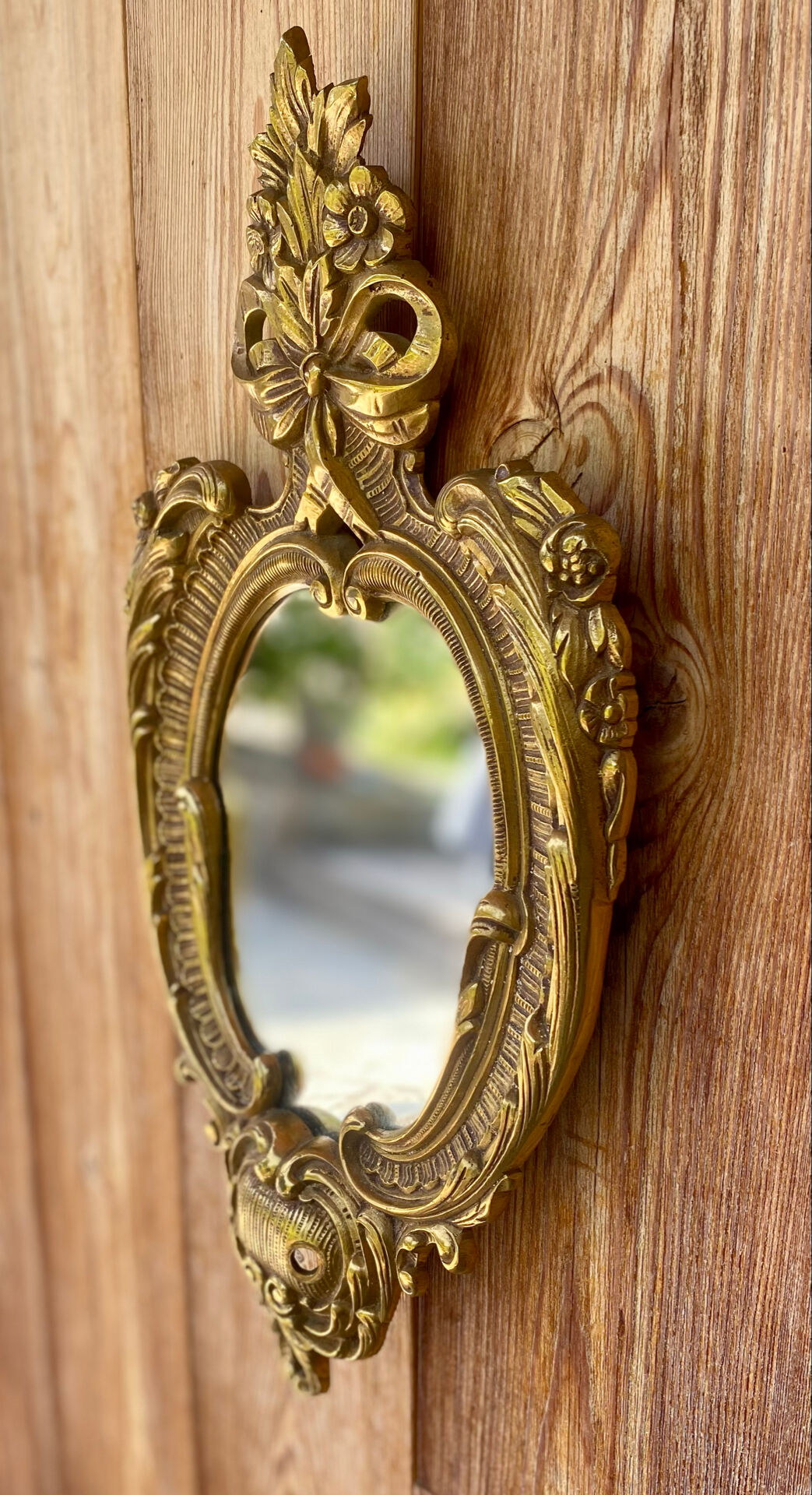 oval decorative wall mirror in Louis XV style