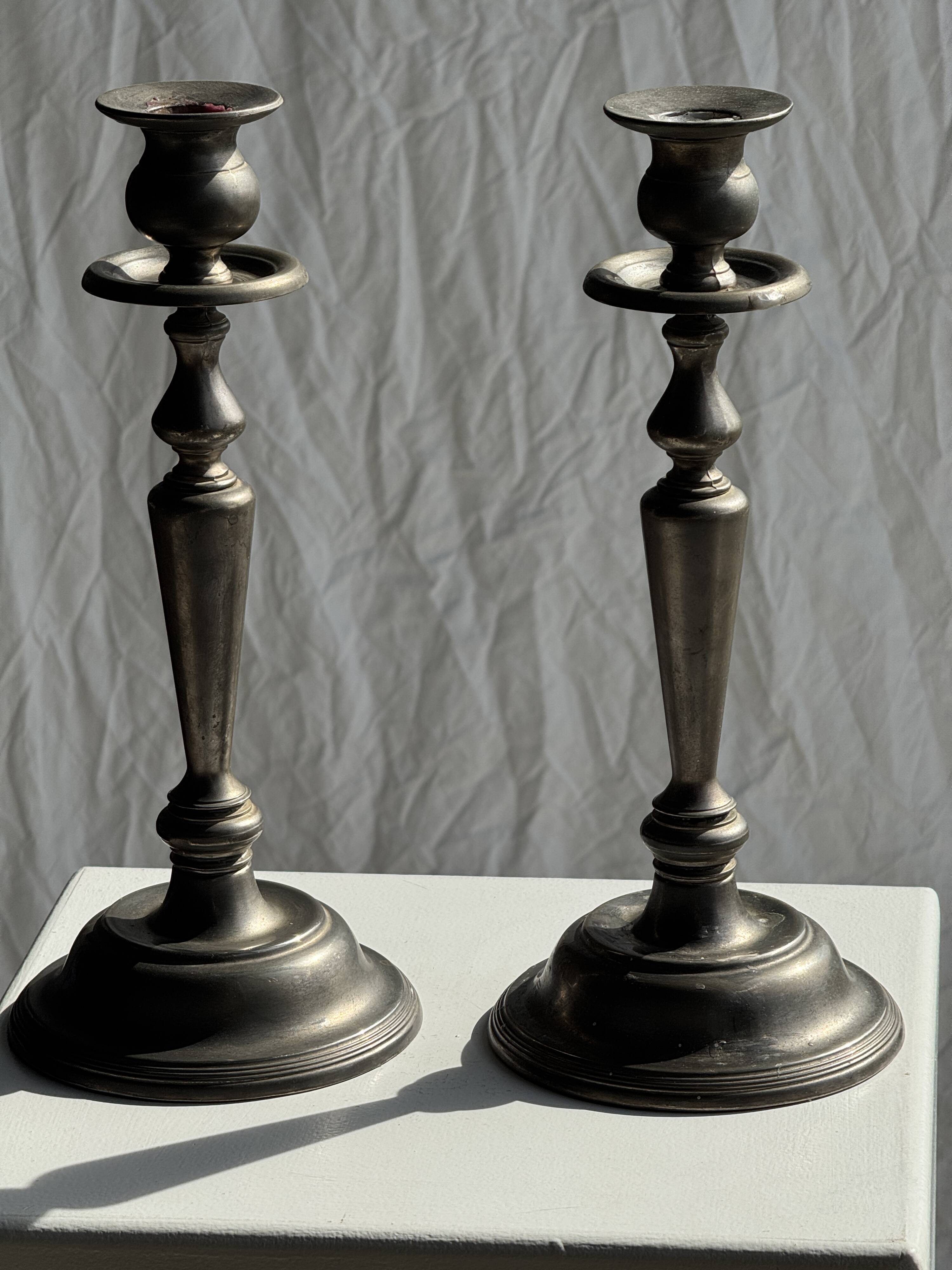 Two large antique silver-plated metal candlesticks, H30
