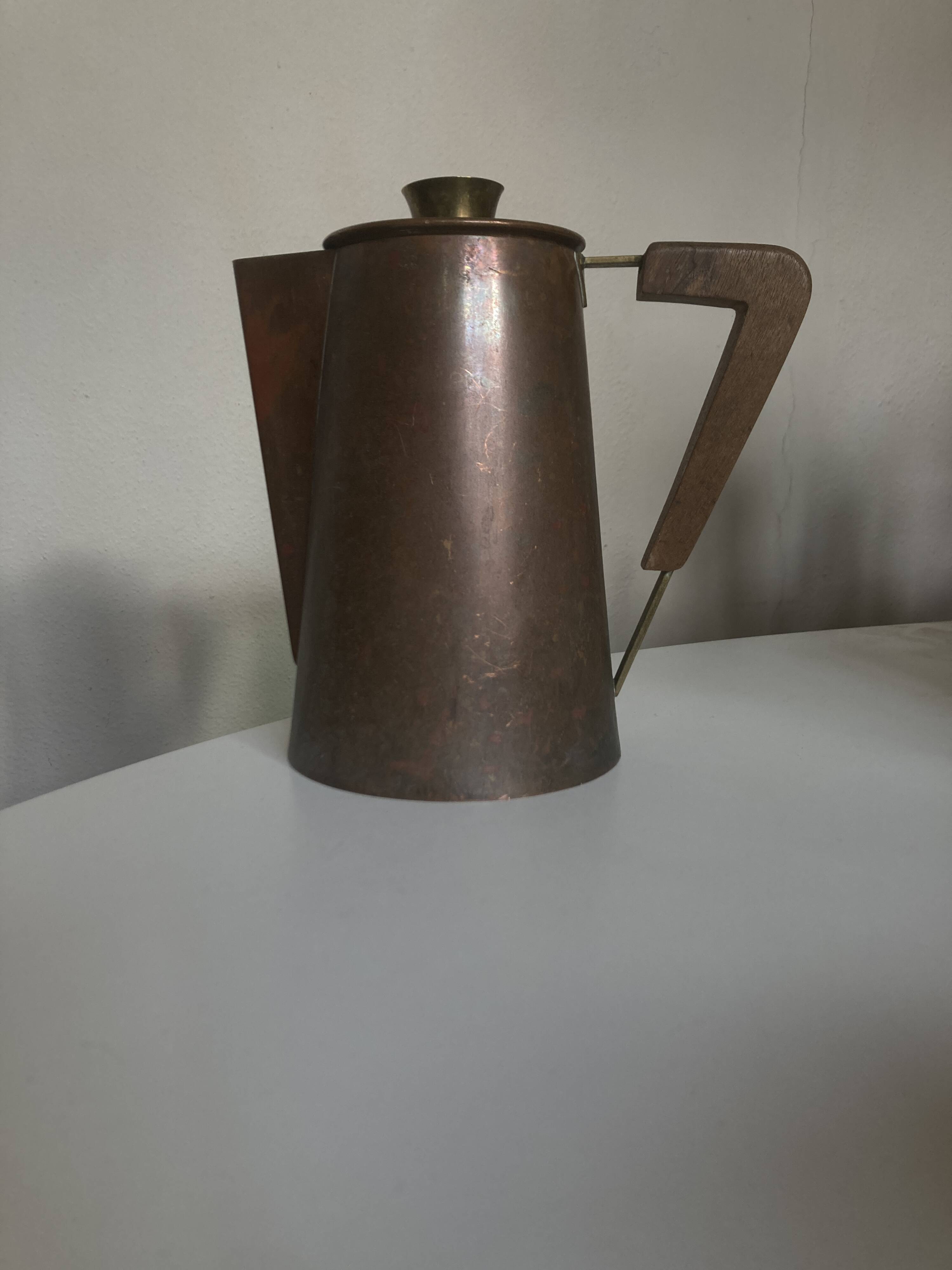 Modernist Italian pitcher design from the 1960s in patinated wood and metal.