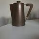 Modernist Italian pitcher design from the 1960s in patinated wood and metal.