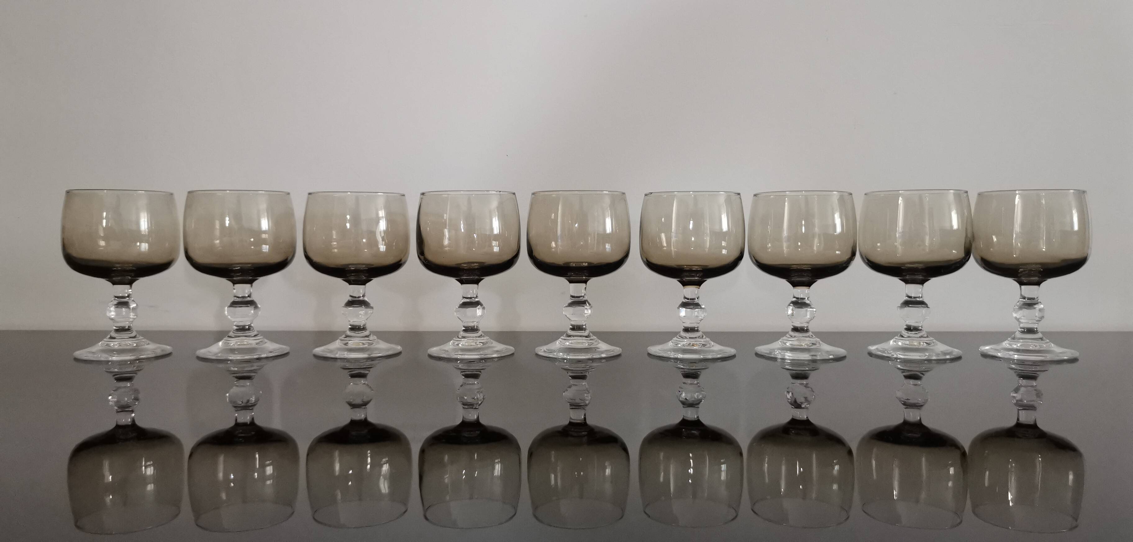 9 white wine glasses on vintage Luminarc smoked black stem