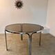 Table ronde vintage tubulaire en métal et verre fumé design année 70