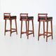 Erik Buck set of three bar stools in teak and leather Dyrlund Denmark 1960