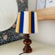 Vintage lamp with turned wooden base, striped wool lampshade