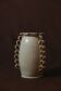 White glazed stoneware vase decorated with raised ribbons.