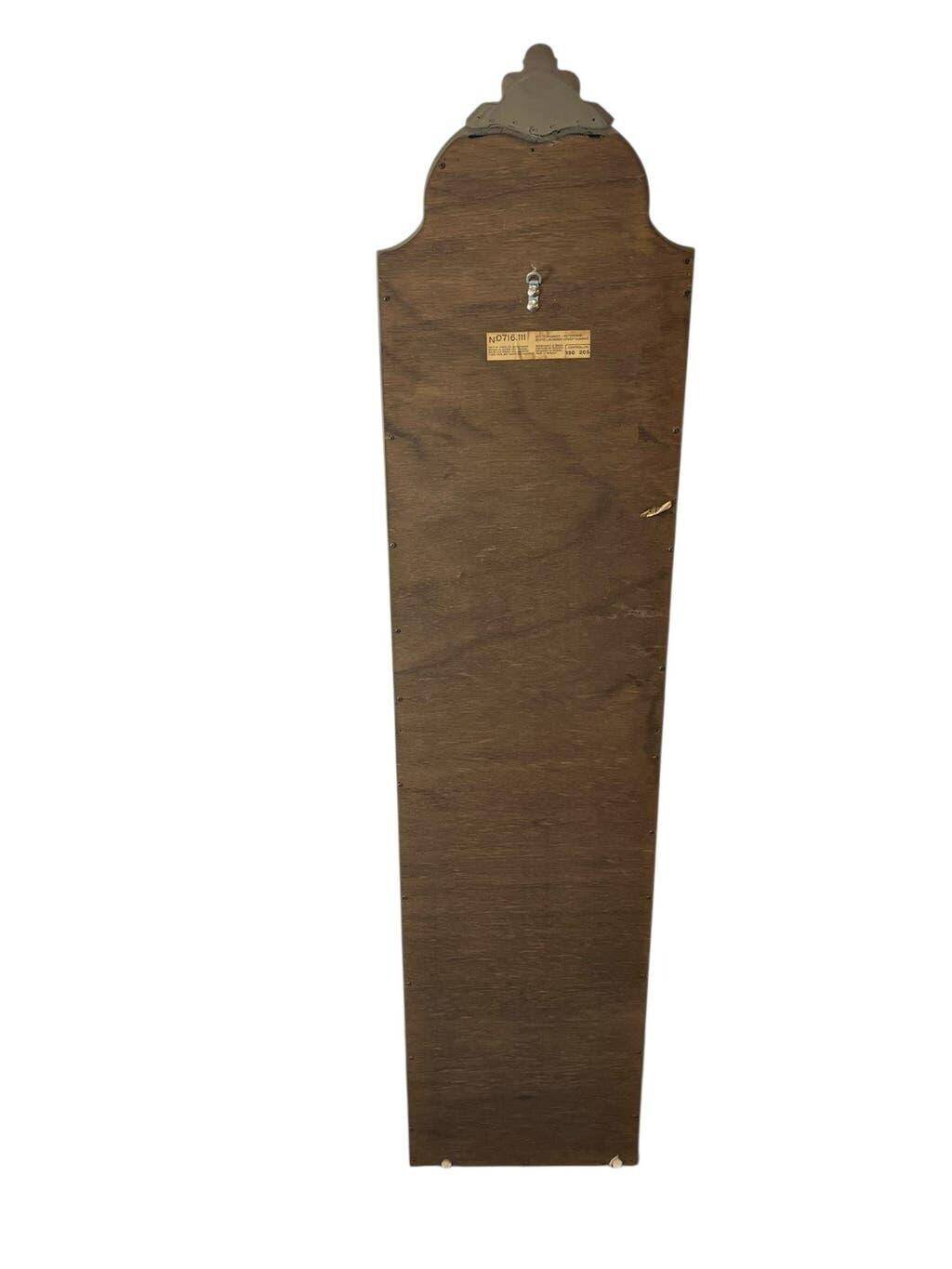 Narrow and tall antique mirror, adorned with golden patterns.