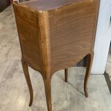 A bedside table with a drawer and a niche in Louis XV style.