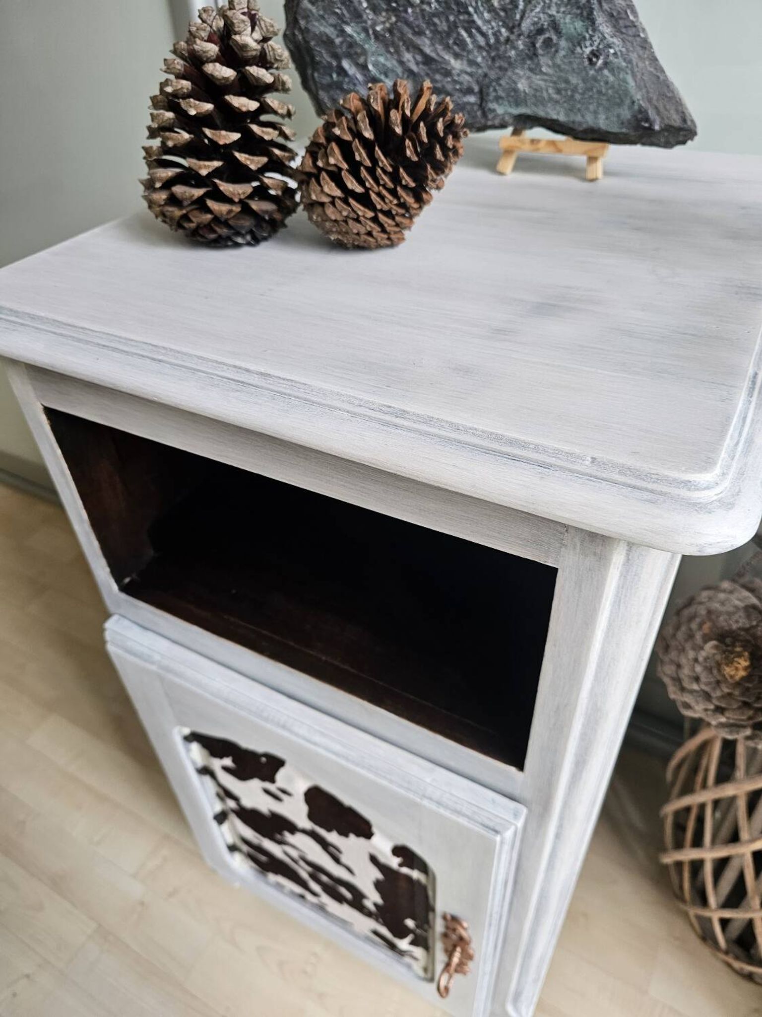 Two solid wood bedside tables with calfskin decoration.