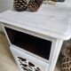 Two solid wood bedside tables with calfskin decoration.
