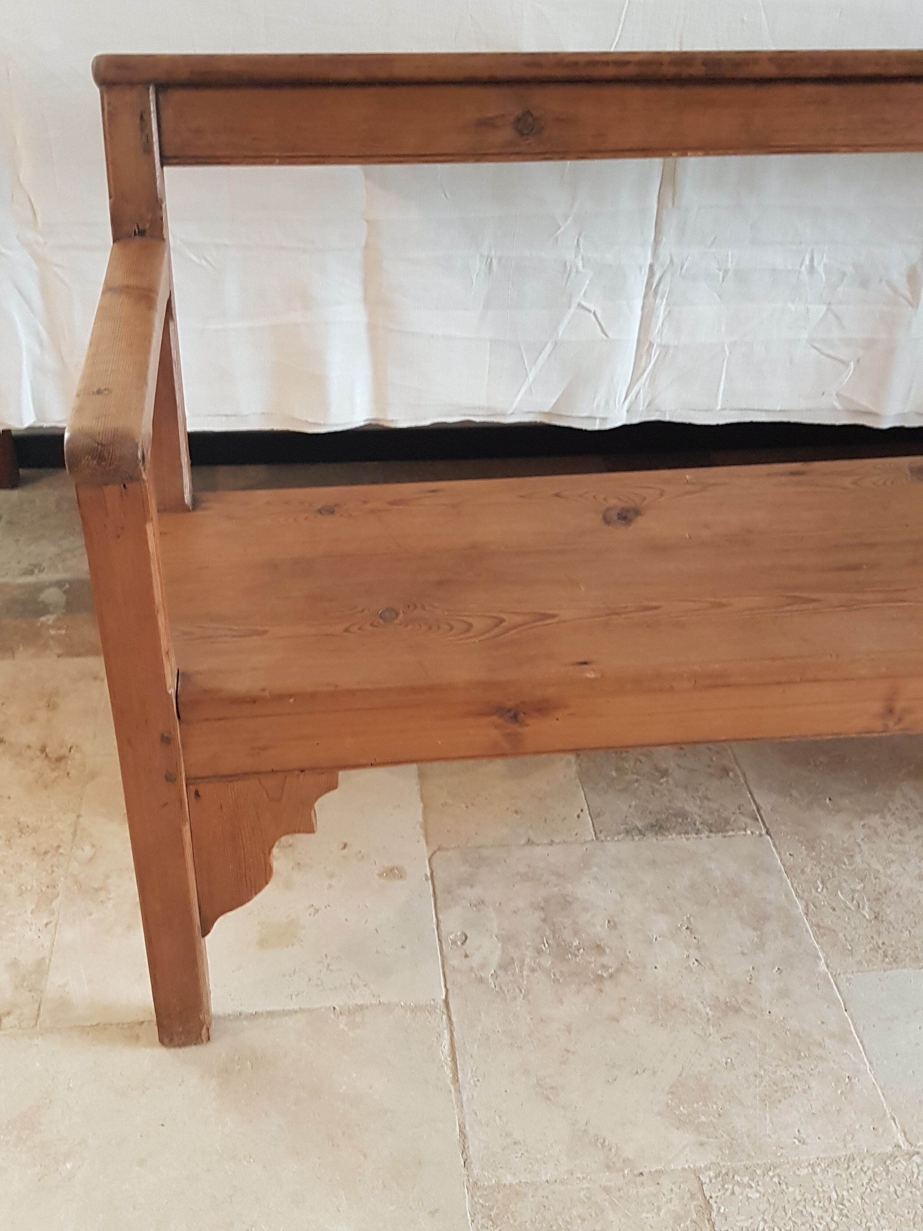 Church bench in fir tree with armrests