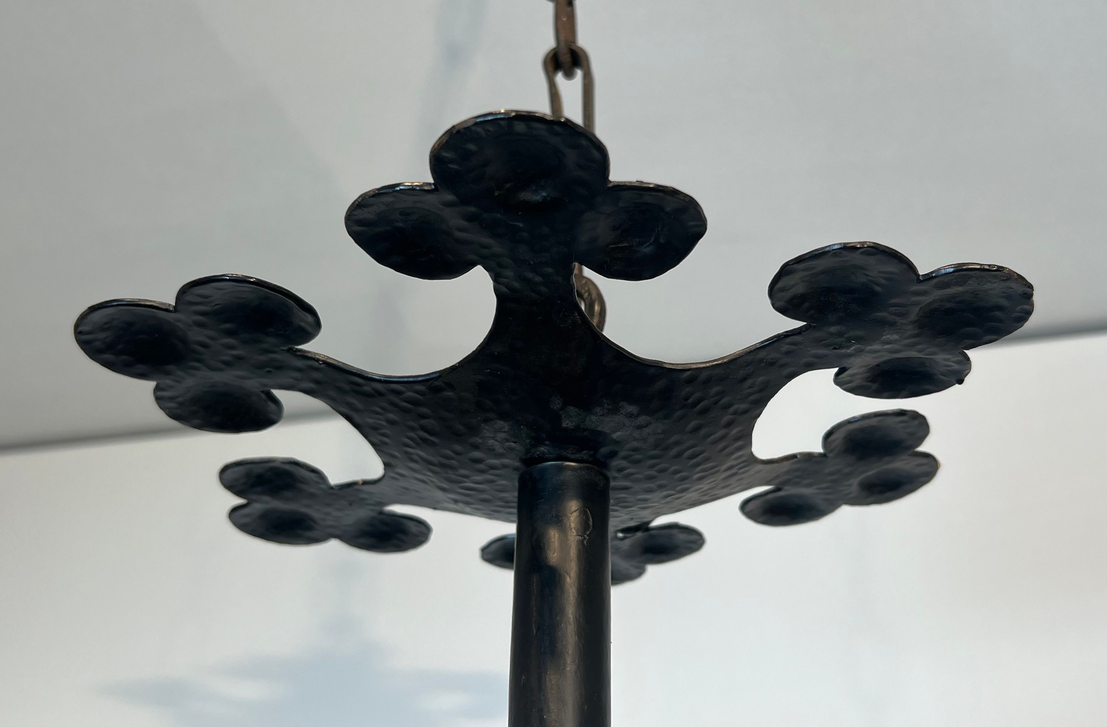 Lustre with 12 lights in wrought iron decorated with clovers and foliage.