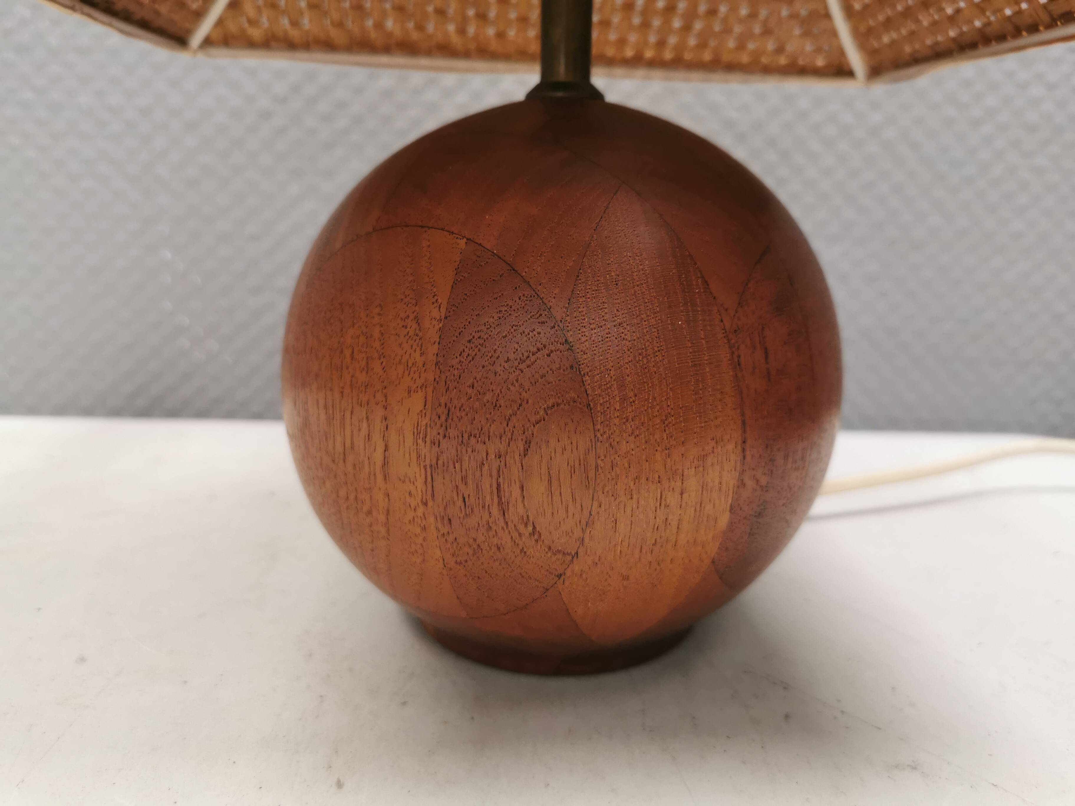 Very rare table lamp in turned teak wood with original braided shade. 1970s