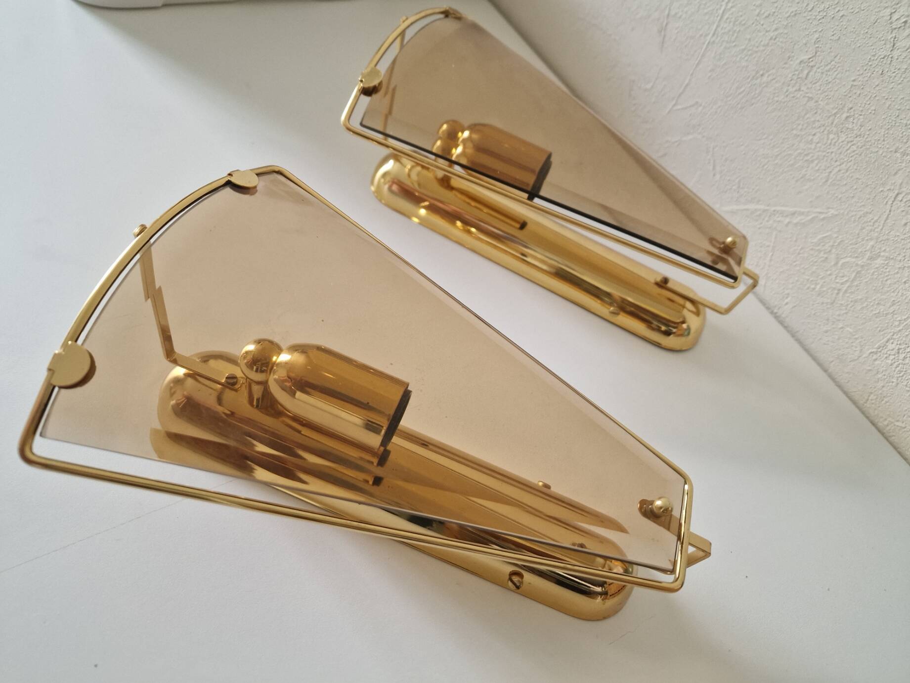Pair of wall lights in brass and smoked glass by Lakro Amstelveen.