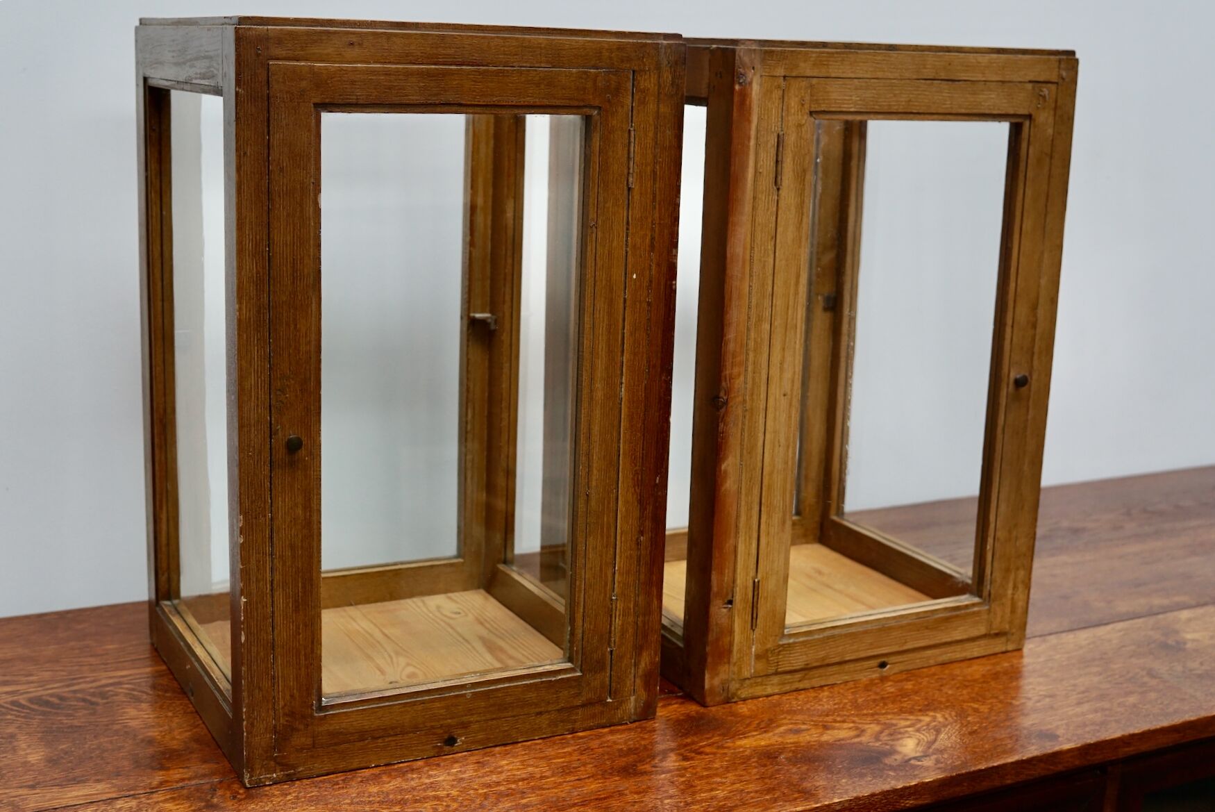 pair of faux oak shop display cabinets, circa 1920s