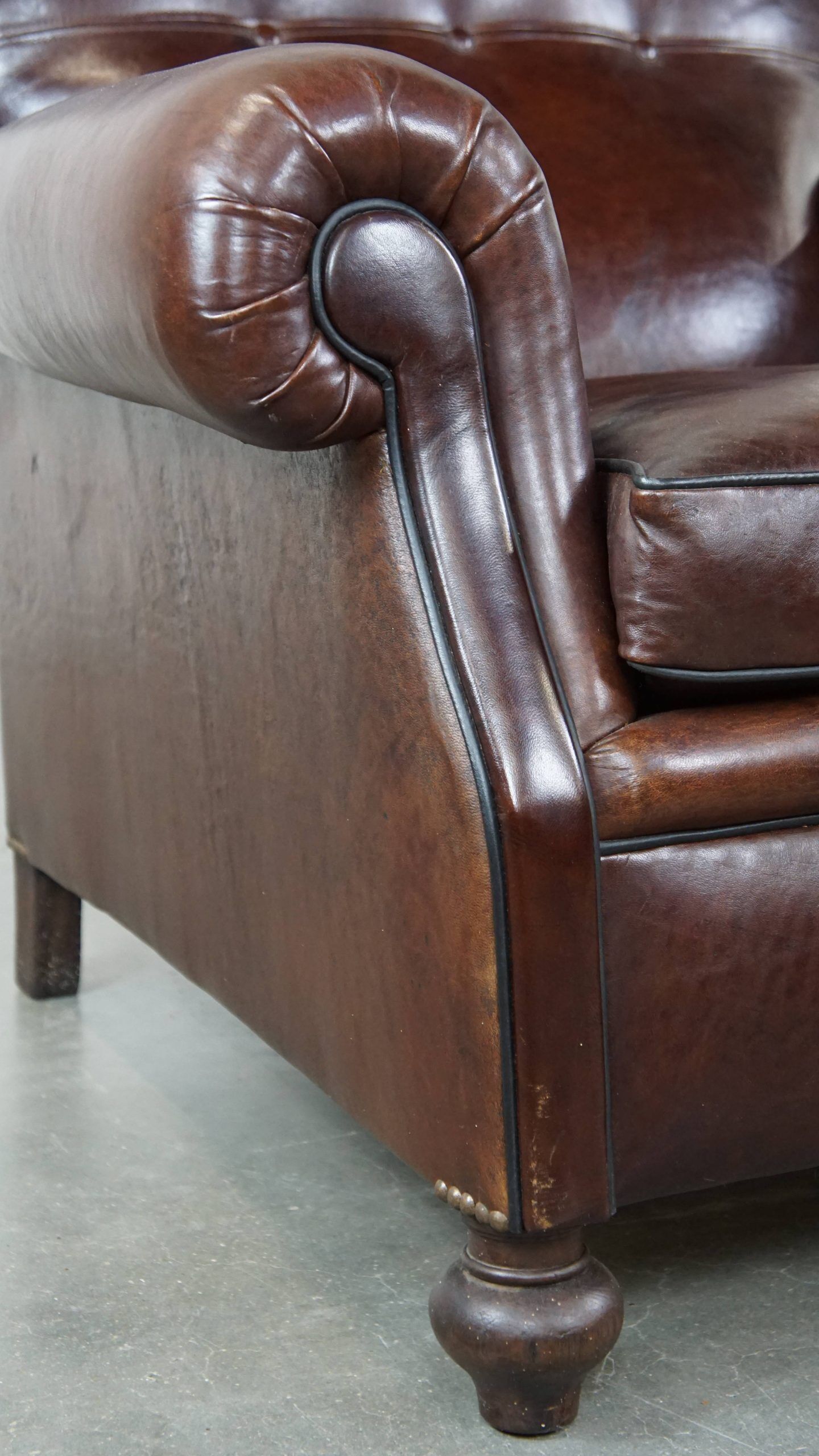 Comfortable and correct dark antique sheepskin English armchair in very good condition