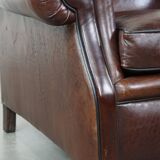 Comfortable and correct dark antique sheepskin English armchair in very good condition