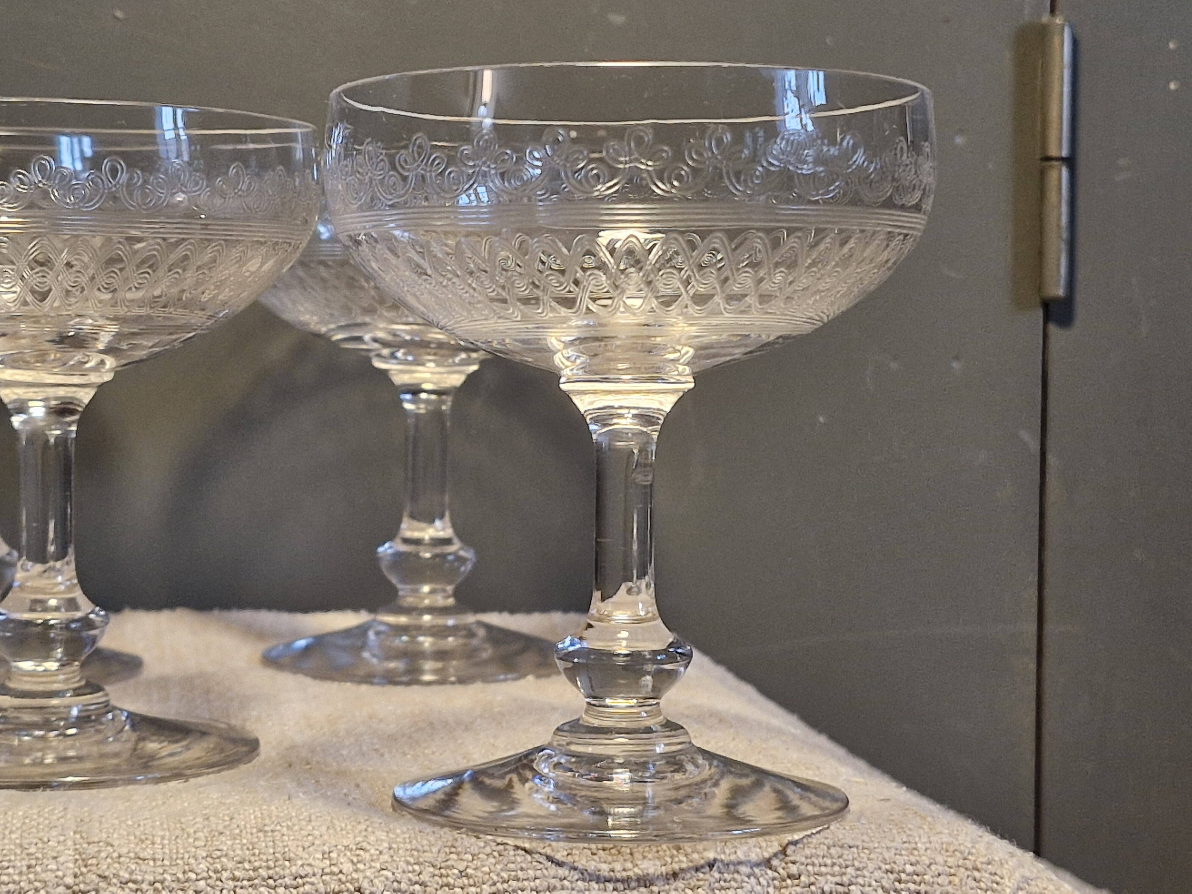 8 antique Baccarat crystal champagne coupes with engraved decoration.