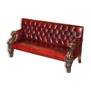 Victorian Chesterfield leather sofa with carved lion heads.
