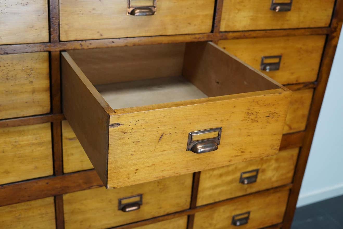 School cabinet bank of vintage Dutch drawers in mid-twentieth century pine