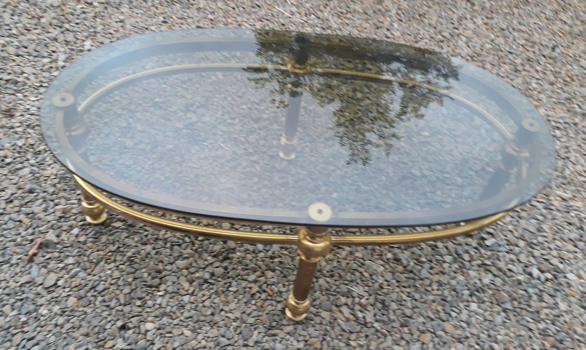 Oval coffee table in gilded brass and smoked glass 1970