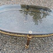 Oval coffee table in gilded brass and smoked glass 1970