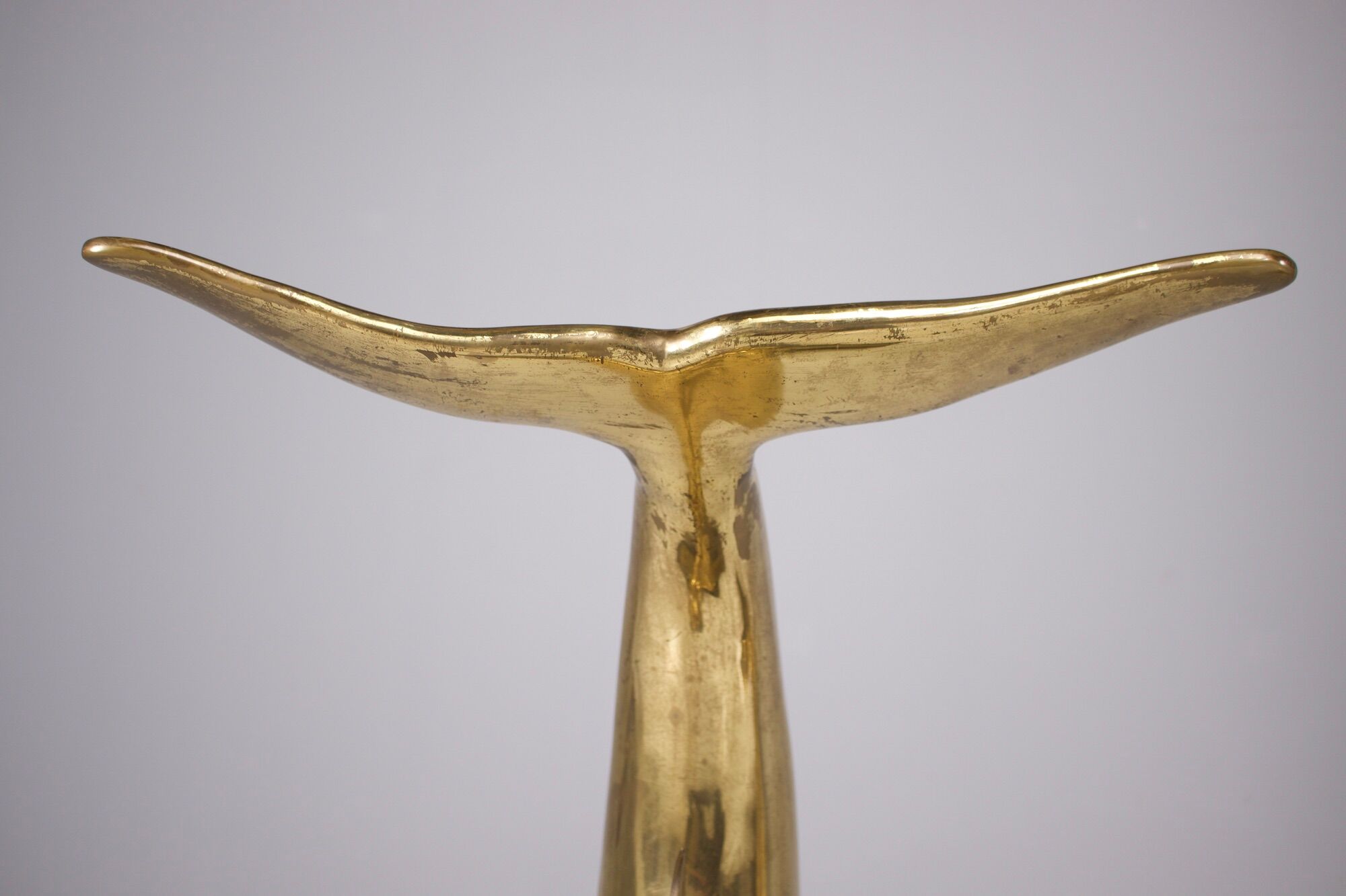 Solid brass dolphin console feet.