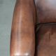 Great luxurious brown cowhide club armchair with matching piping