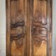 Antique walnut armoire with two doors.
