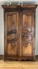 Antique walnut armoire with two doors.