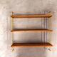 Vintage wall shelf in teak and golden brass String Tomado style
