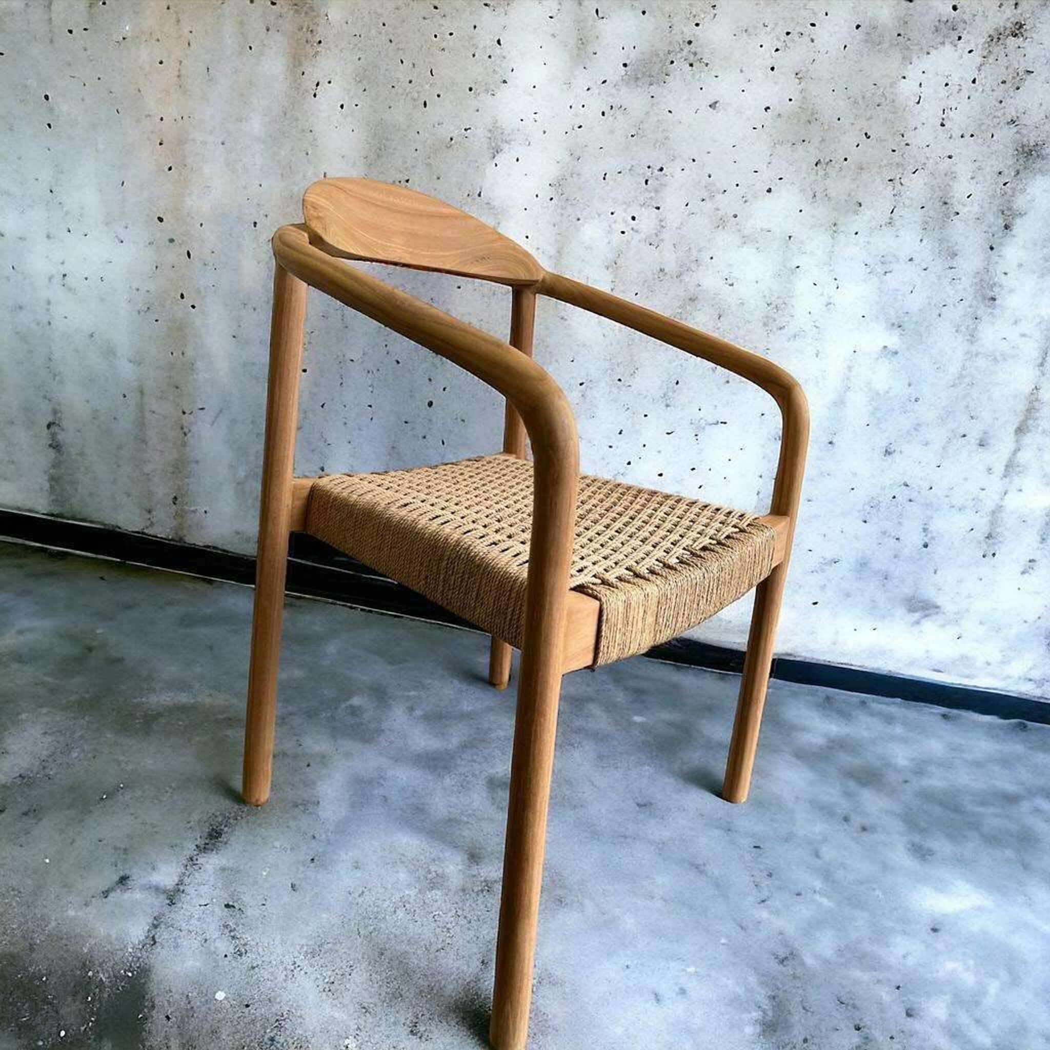Solid wood chair with weaved seat and armrests